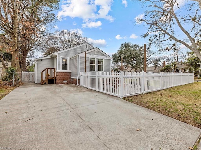 exterior space with brick siding and a fenced front yard