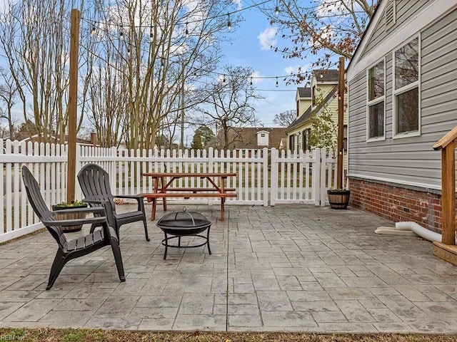 view of patio featuring a fire pit and fence