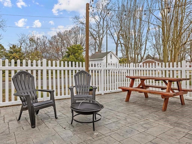 view of patio featuring a fire pit and fence