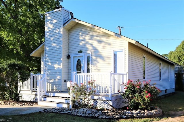 view of front of home with a porch and a chimney