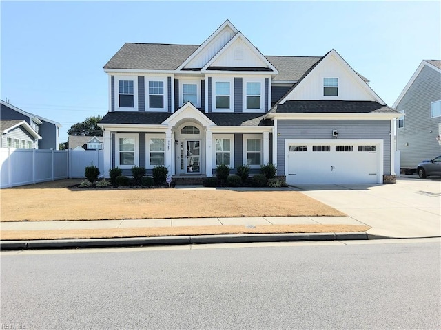 view of front of house with board and batten siding, concrete driveway, an attached garage, and fence