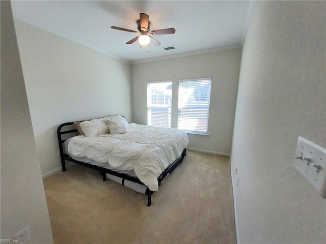 bedroom with light carpet, visible vents, crown molding, and baseboards