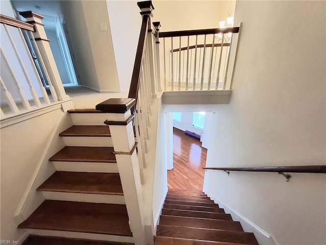 staircase with wood finished floors and visible vents