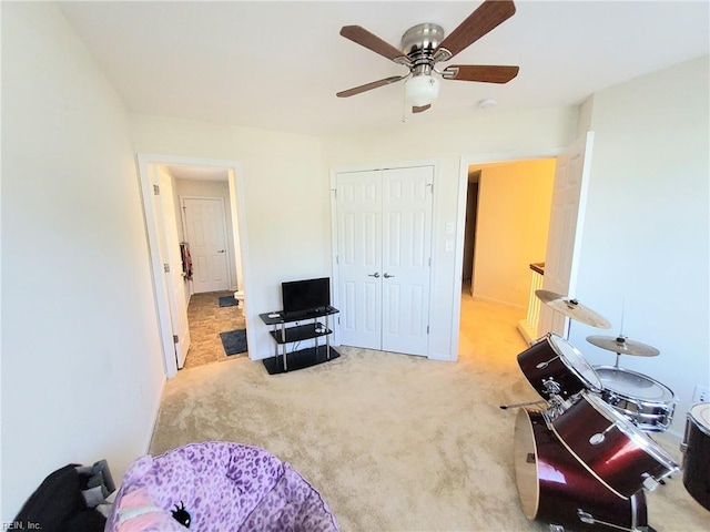 bedroom with a closet, carpet, and ceiling fan