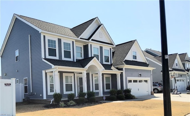 view of front of house with a garage, concrete driveway, and a shingled roof