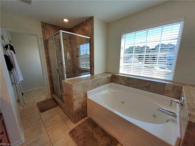 full bath with a shower stall, a tub with jets, and tile patterned floors