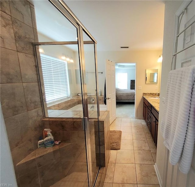 full bathroom with tile patterned floors, visible vents, a stall shower, and ensuite bathroom