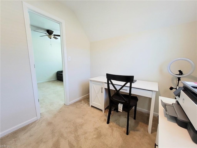 home office featuring light colored carpet, baseboards, ceiling fan, and vaulted ceiling