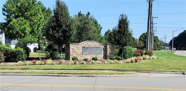 community / neighborhood sign with a lawn