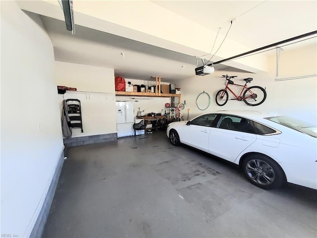 garage featuring a garage door opener and white fridge with ice dispenser