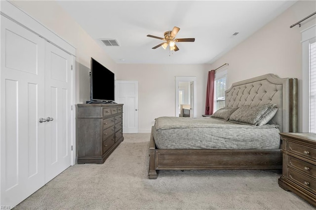 bedroom featuring visible vents, light carpet, and ceiling fan