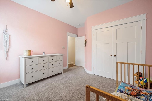 bedroom with ceiling fan, baseboards, a closet, and light carpet