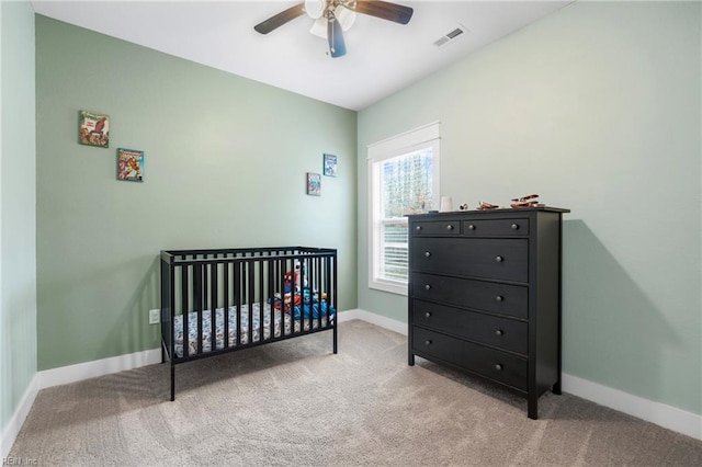 bedroom with baseboards, carpet, and a crib