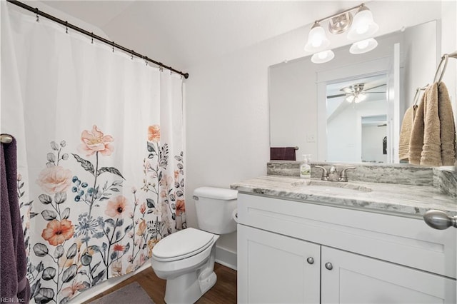 bathroom with vanity, a shower with shower curtain, wood finished floors, a ceiling fan, and toilet