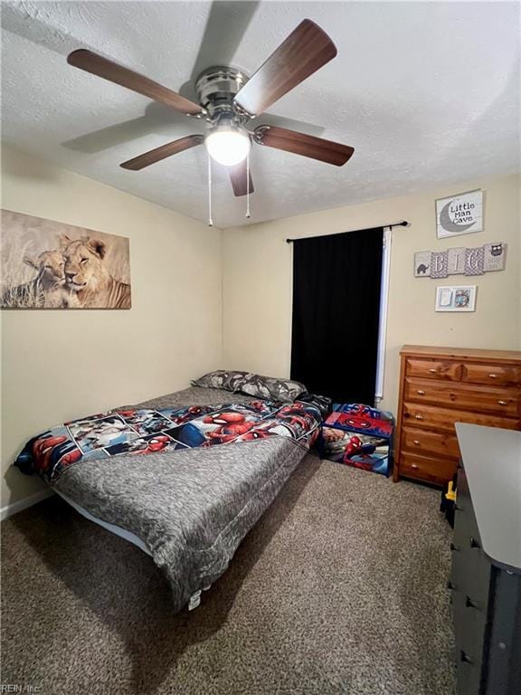 carpeted bedroom with a textured ceiling and a ceiling fan