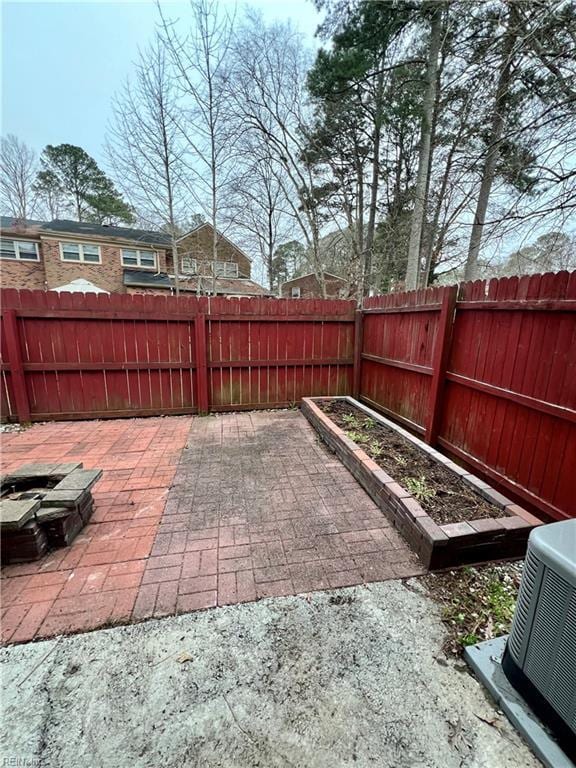 view of patio / terrace with a garden, cooling unit, and a fenced backyard