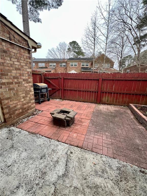 view of patio / terrace with grilling area, an outdoor fire pit, and a fenced backyard