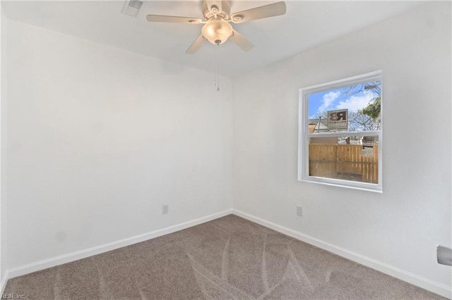 carpeted empty room featuring visible vents, baseboards, and ceiling fan