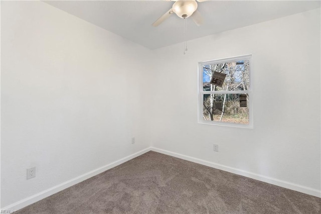 empty room with dark carpet, baseboards, and ceiling fan