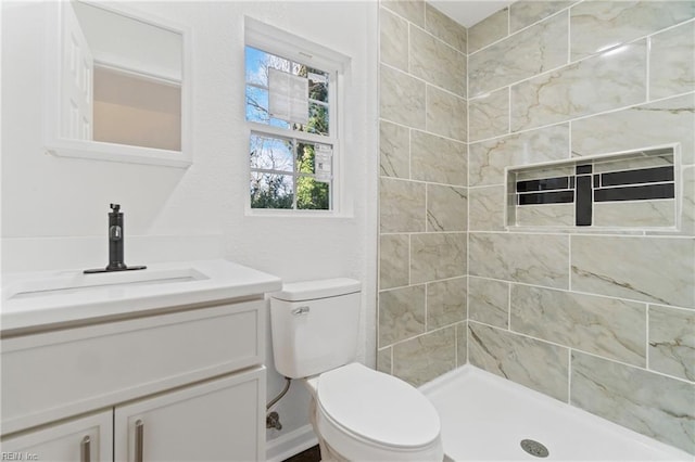 full bathroom with toilet, a shower stall, and vanity