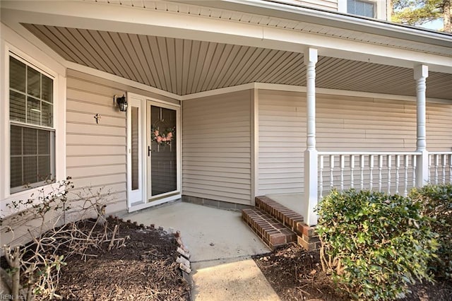 view of exterior entry featuring a porch