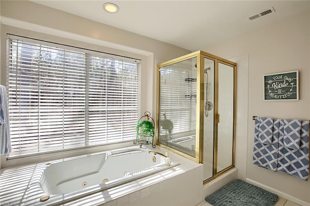 bathroom featuring visible vents, plenty of natural light, a stall shower, and a tub with jets