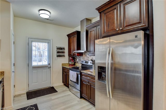 kitchen with tasteful backsplash, stainless steel appliances, dark brown cabinetry, light wood finished floors, and light stone countertops