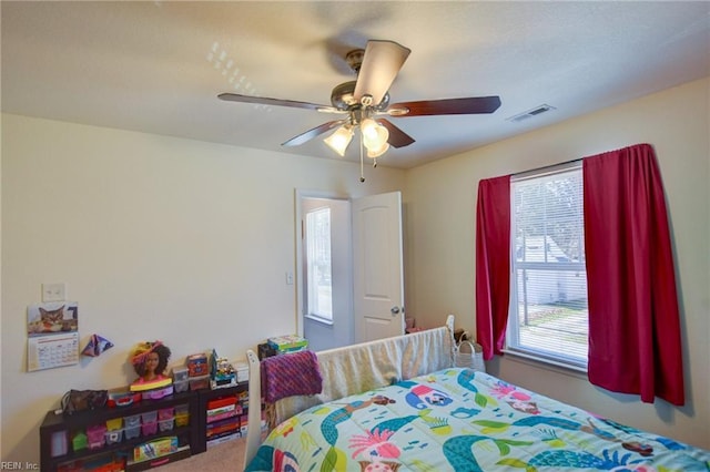 bedroom with visible vents and a ceiling fan