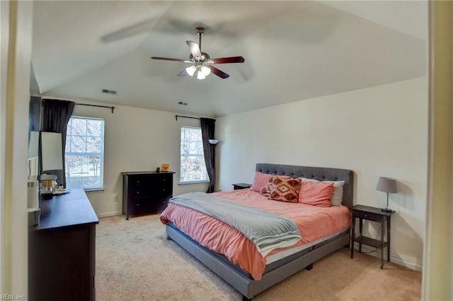 bedroom featuring lofted ceiling, baseboards, visible vents, and light carpet