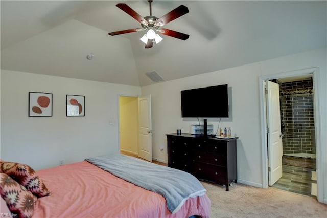 bedroom with a ceiling fan, baseboards, lofted ceiling, ensuite bathroom, and light colored carpet