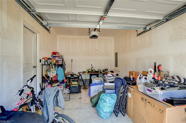 garage featuring electric panel and a garage door opener