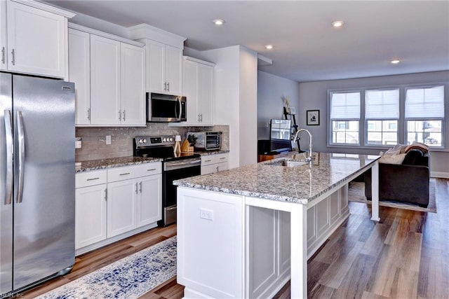 kitchen featuring a sink, white cabinetry, and stainless steel appliances