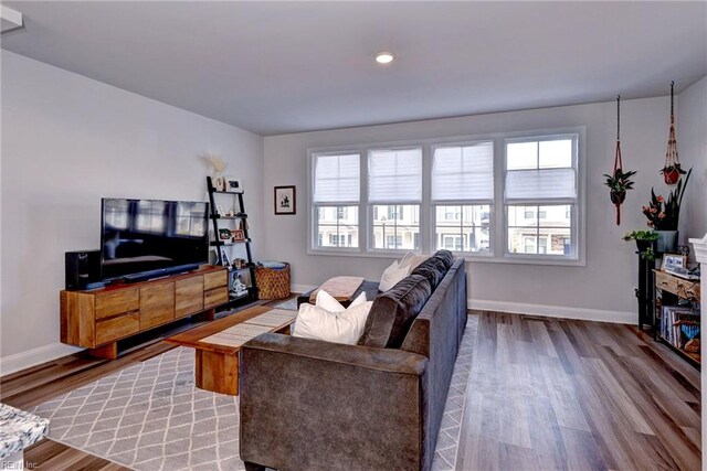 living room with wood finished floors and baseboards