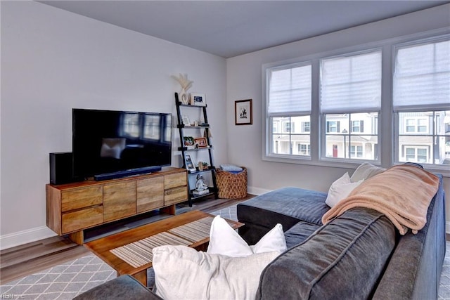 living area featuring wood finished floors and baseboards