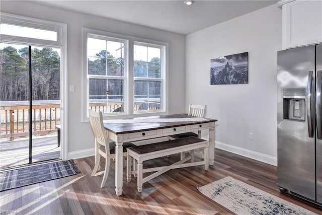 dining space with baseboards and dark wood-style flooring