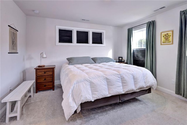 carpeted bedroom with visible vents and baseboards