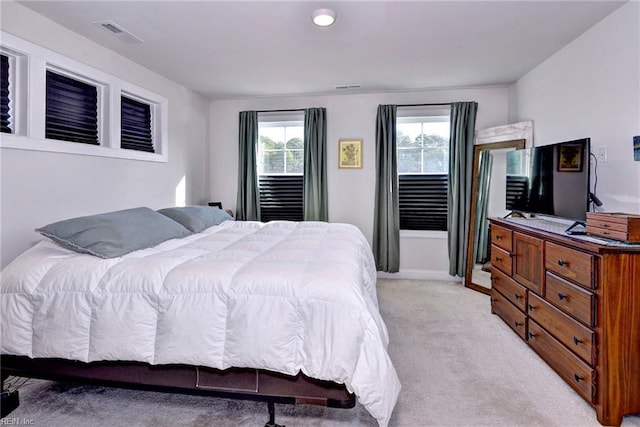 bedroom with visible vents and light colored carpet