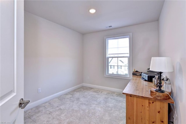 office with visible vents, light colored carpet, and baseboards