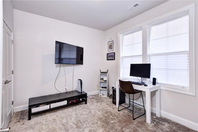 office space featuring carpet flooring, baseboards, and visible vents