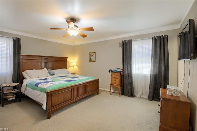 bedroom featuring baseboards, light colored carpet, ceiling fan, and crown molding