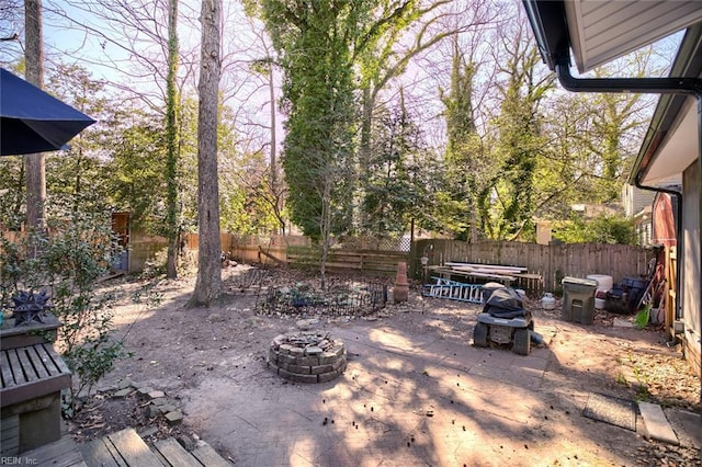 view of patio with a fenced backyard and an outdoor fire pit