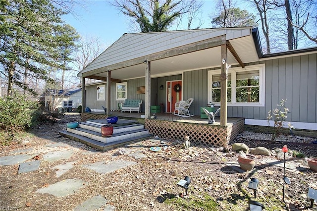 view of front facade with board and batten siding and covered porch