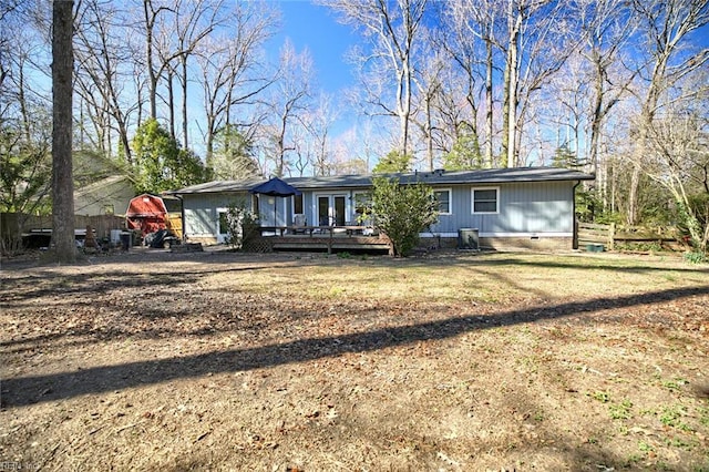 view of front of property featuring crawl space, a wooden deck, and french doors