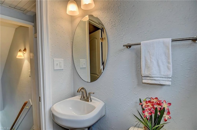 bathroom with a sink and a textured wall