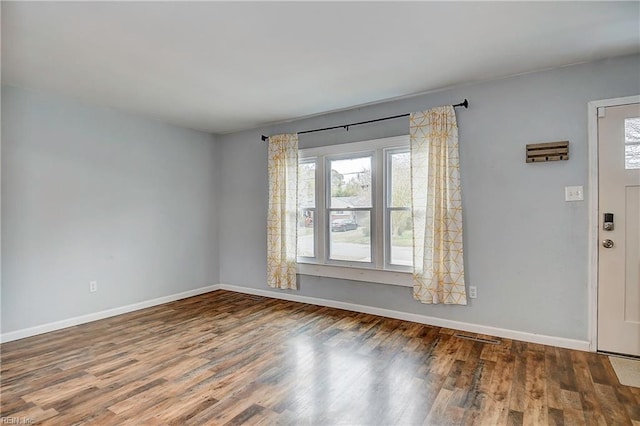 entrance foyer featuring baseboards and wood finished floors