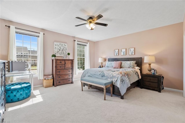 bedroom with a ceiling fan, carpet floors, and baseboards