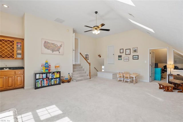 recreation room with lofted ceiling, light colored carpet, a sink, ceiling fan, and indoor wet bar