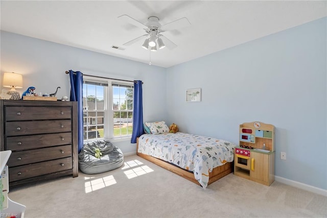 carpeted bedroom featuring baseboards, ceiling fan, and visible vents