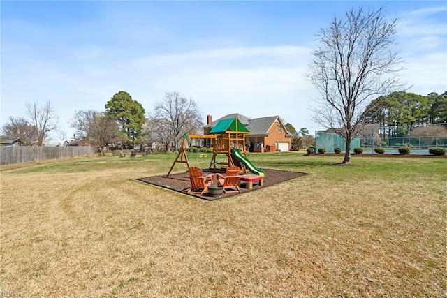 view of play area with fence and a lawn