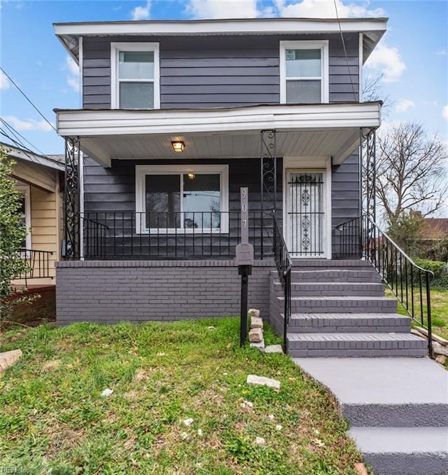 view of front facade with a porch and brick siding